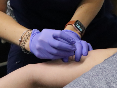 A physical therapist performing dry needling to a patient
