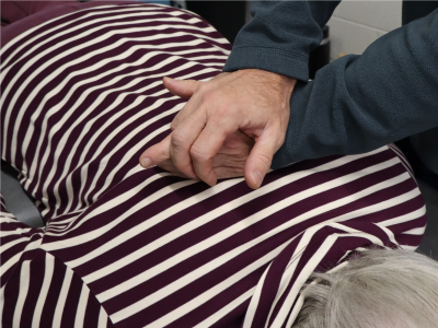 A physical therapist performing manual therapy on a patient