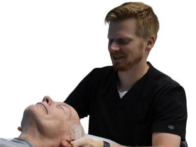 A physical therapist guiding a patient with jaw and head pain